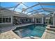 Inviting pool and spa area with covered patio at 85 Sugar Mill Dr, Osprey, FL 34229
