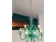 Close-up view of a stunning green glass chandelier at 10555 Old Grove Cir, Bradenton, FL 34212