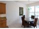 Kitchen dining area with a round table and four chairs, adjacent to a window at 10555 Old Grove Cir, Bradenton, FL 34212