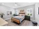 Cozy bedroom with wood bed frame, gray walls, and white shutters at 12735 Aquamarine Ave, Bradenton, FL 34211