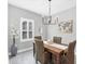 Bright dining area with wooden table, rattan chairs, and a world map print at 12735 Aquamarine Ave, Bradenton, FL 34211