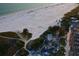 Aerial view of Siesta Beach, showing shoreline, volleyball courts, and parking at 1430 Harbor Dr, Sarasota, FL 34239