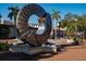 Modern art sculpture in a city park with palm trees, clock tower, and shops at 1430 Harbor Dr, Sarasota, FL 34239