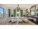 Elegant dining room features a marble table, chandelier, and green curtains at 1430 Harbor Dr, Sarasota, FL 34239