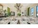 Elegant dining room with marble table, chandelier, and green accents at 1430 Harbor Dr, Sarasota, FL 34239