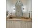 Powder room boasts a marble vanity, ornate mirror, and elegant light fixtures at 1430 Harbor Dr, Sarasota, FL 34239