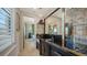 Wet bar with black countertop, gold accents, and glass shelving at 1430 Harbor Dr, Sarasota, FL 34239