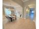 Bright dining room with a dark wood table, chandelier, and access to the kitchen at 19025 Fern Meadow Loop, Lutz, FL 33558