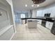 Kitchen with island, white cabinets, granite countertops, and stainless steel appliances at 19025 Fern Meadow Loop, Lutz, FL 33558