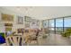 Living area with glass-top table and open kitchen at 1932 Harbourside Dr # 232, Longboat Key, FL 34228