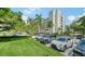 Ample parking lot with landscaping and nearby building at 1932 Harbourside Dr # 232, Longboat Key, FL 34228