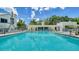 Inviting community pool with lounge chairs at 1932 Harbourside Dr # 232, Longboat Key, FL 34228