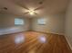 Spacious bedroom with wood floors and ceiling fan at 461 S Florida Ave, Tarpon Springs, FL 34689