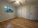 Well-lit bedroom with wood floors and an exterior door at 461 S Florida Ave, Tarpon Springs, FL 34689