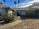 Front door entrance with a curved walkway leading to the house at 461 S Florida Ave, Tarpon Springs, FL 34689