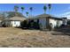 Side view of a light blue house with palm trees and a large yard at 461 S Florida Ave, Tarpon Springs, FL 34689