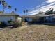 Front view of a light blue house with a walkway to the entrance at 461 S Florida Ave, Tarpon Springs, FL 34689