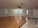 Large living room with wood floors and multiple windows at 461 S Florida Ave, Tarpon Springs, FL 34689