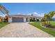 Front view of a single-story home with a gray garage door and paved driveway at 468 Leger Dr, Nokomis, FL 34275