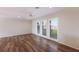 Spacious living room with hardwood floors and large windows at 468 Leger Dr, Nokomis, FL 34275