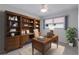 Home office with built-in wooden desk and shelving at 468 Leger Dr, Nokomis, FL 34275