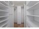 Spacious walk-in closet offers ample storage with built-in shelves at 468 Leger Dr, Nokomis, FL 34275