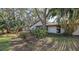 Peaceful backyard with lush landscaping and a view of the home at 4720 Oak Forest W Dr # 57, Sarasota, FL 34231