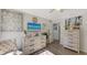 Bright bedroom with dresser, TV, and comfortable armchair at 4720 Oak Forest W Dr # 57, Sarasota, FL 34231