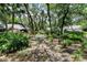 Landscaped community area with a bench and walkway at 4720 Oak Forest W Dr # 57, Sarasota, FL 34231