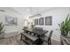 Elegant dining room with a modern chandelier and seating for six at 4720 Oak Forest W Dr # 57, Sarasota, FL 34231