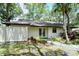 Exterior view of the home with a white fence and lush landscaping at 4720 Oak Forest W Dr # 57, Sarasota, FL 34231