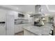 Updated kitchen featuring white cabinets and granite countertops at 4720 Oak Forest W Dr # 57, Sarasota, FL 34231