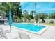 Community pool with lounge chairs and umbrellas at 4720 Oak Forest W Dr # 57, Sarasota, FL 34231