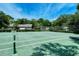 Community tennis court surrounded by lush landscaping at 4720 Oak Forest W Dr # 57, Sarasota, FL 34231