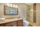 Bathroom with granite vanity and tiled shower at 50 Lighthouse Point Dr, Longboat Key, FL 34228