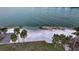 Private beach access with white sand and palm trees at 50 Lighthouse Point Dr, Longboat Key, FL 34228