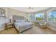 Bedroom with light wood floors and window seat at 50 Lighthouse Point Dr, Longboat Key, FL 34228