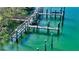 Aerial view of private boat docks on a calm waterway at 50 Lighthouse Point Dr, Longboat Key, FL 34228