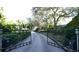 Gated community entrance with brick pavers and lush landscaping at 50 Lighthouse Point Dr, Longboat Key, FL 34228