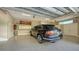 Spacious garage with epoxy flooring and overhead storage at 50 Lighthouse Point Dr, Longboat Key, FL 34228