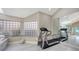 Bright home gym with two treadmills and natural light at 50 Lighthouse Point Dr, Longboat Key, FL 34228