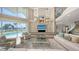 Two story living room with water views and a large TV at 50 Lighthouse Point Dr, Longboat Key, FL 34228