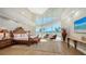 Luxurious main bedroom with water views and sitting area at 50 Lighthouse Point Dr, Longboat Key, FL 34228