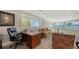 Home office with water views and built-in desk at 50 Lighthouse Point Dr, Longboat Key, FL 34228