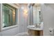 Stylish powder room with granite vanity and etched glass accents at 50 Lighthouse Point Dr, Longboat Key, FL 34228