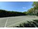 Well-maintained tennis court with surrounding hedges at 50 Lighthouse Point Dr, Longboat Key, FL 34228