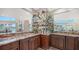 Elegant wet bar with granite countertop and mirrored backsplash at 50 Lighthouse Point Dr, Longboat Key, FL 34228