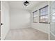 Bright bedroom with neutral walls, carpet flooring, and two windows at 5316 Rocky Coast Place, Palmetto, FL 34221