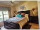 Primary bedroom with dark wood furniture and large window at 5405 Fair Oaks St # 5405, Bradenton, FL 34203