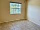 Simple bedroom with tile flooring and large window at 5405 Fair Oaks St # 5405, Bradenton, FL 34203